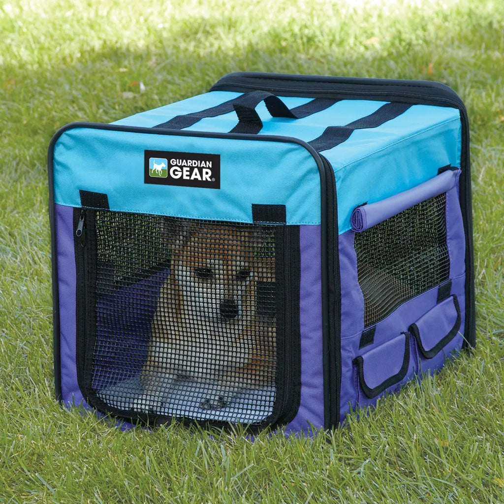 Pet carrier with a dog inside on grass, featuring the Guardian Gear brand.